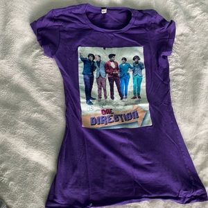 Purple one direction shirt.